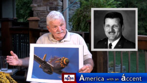 U.S. Air Force Brigadier General Regis F.A. Urschler with a photo of Gunfighter, P-51 Mustang, for America with an Accent with Enkela Vehbiu, in Bellevue, Nebraska.